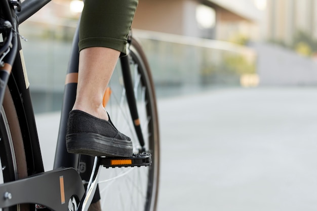 Close-up foot on bicycle pedal