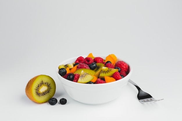 Close-up fork with bowl of fruit