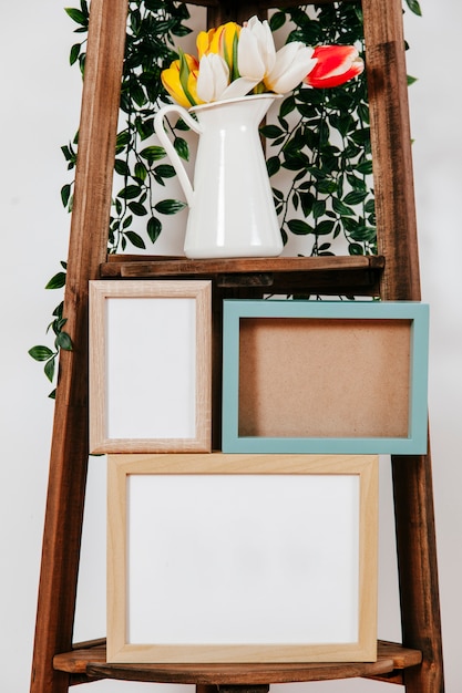 Close-up frames and flowers on shelf