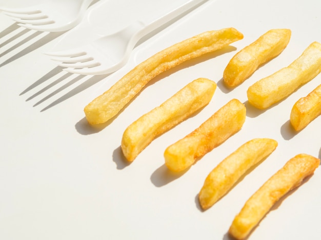 Close-up of french fries and forks