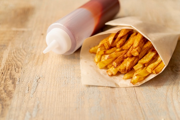 Free photo close-up french friest with ketchup bottle