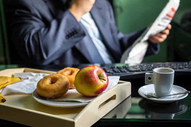 Close-up of fresh apple and donuts