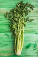 Free photo close-up of fresh celery on green wooden background