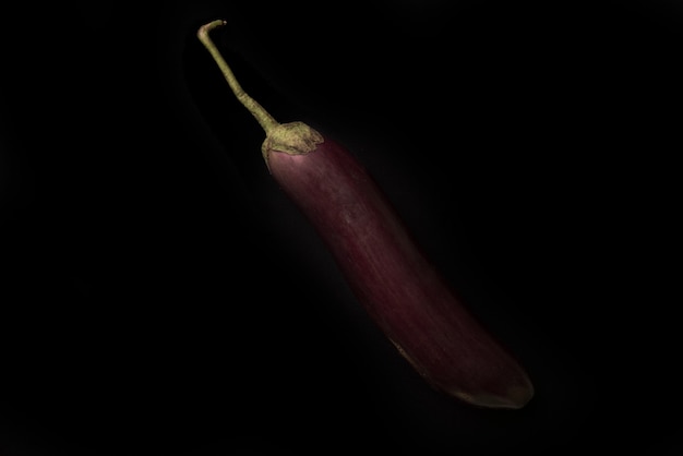 Close up of a fresh eggplant isolated over black