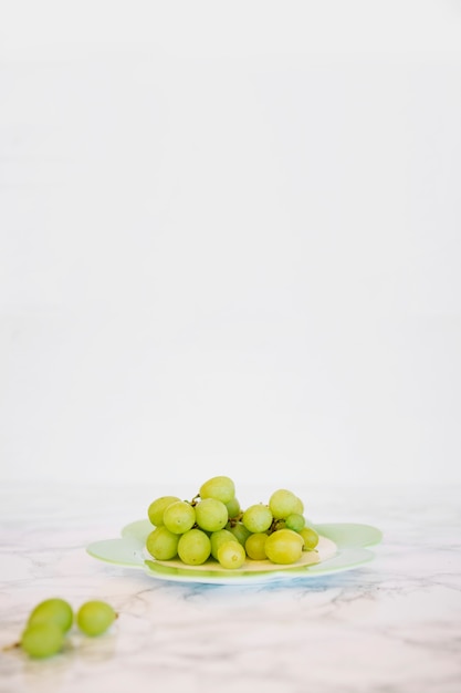Close-up of fresh green grapes on marble