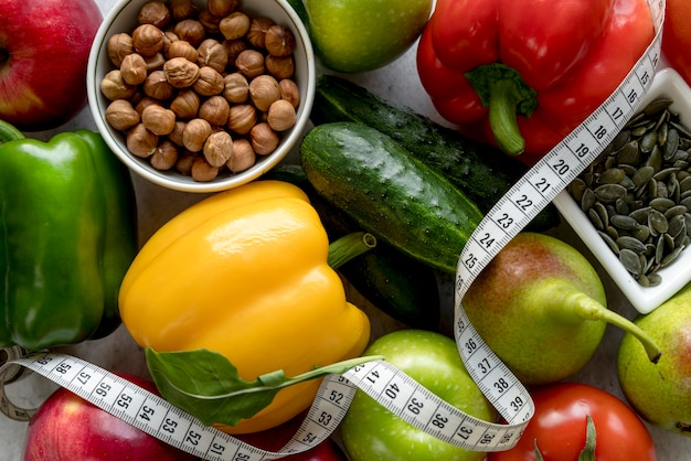 Free photo close-up of fresh healthy fruits and vegetables with measuring tape