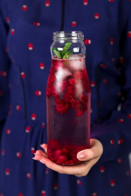 Close up fresh iced raspberry juice in bottle