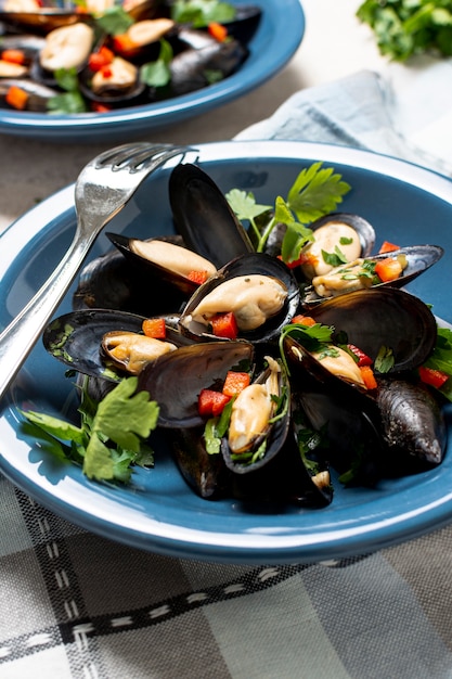 Close-up fresh mussels with parsley on a plate