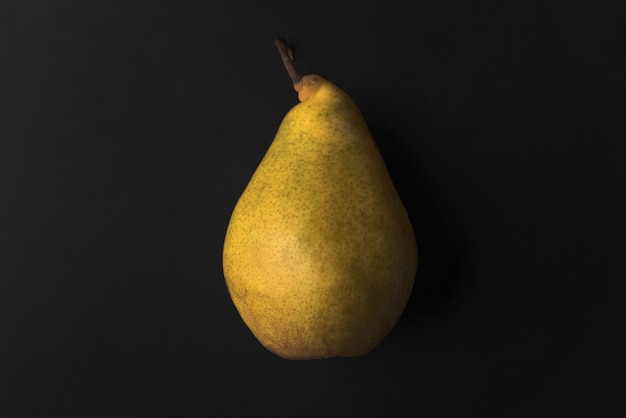 Close up of a fresh pear isolated over black