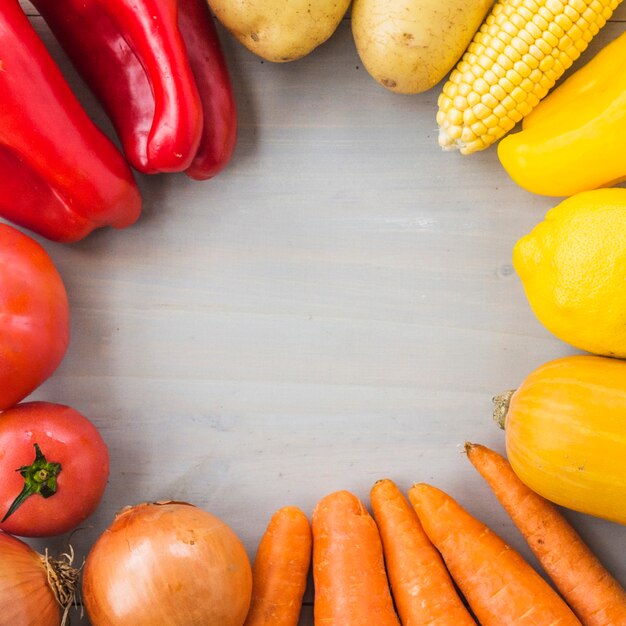 Close-up of fresh raw vegetables forming circular frame