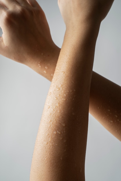 Close up fresh skin arms with water drops