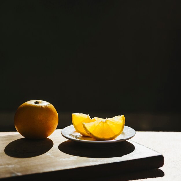 Close-up of fresh sweet lime on chopping board