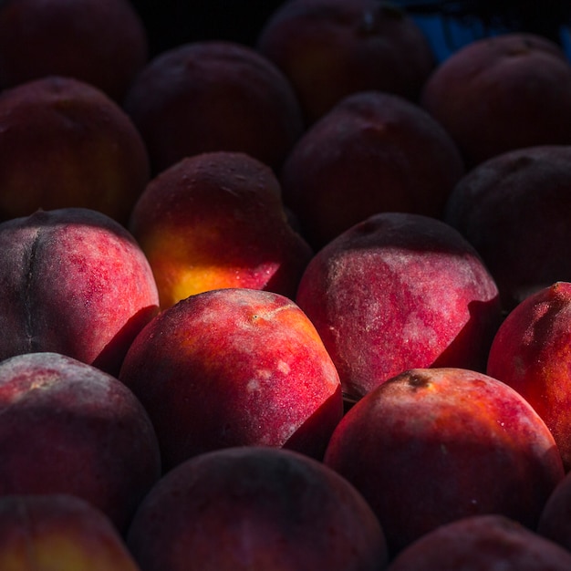 Close-up of fresh whole ripe peaches
