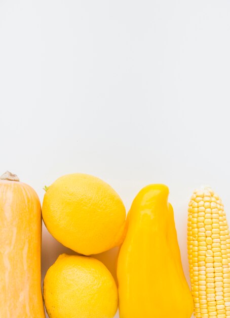 Close-up of fresh yellow vegetables on white background