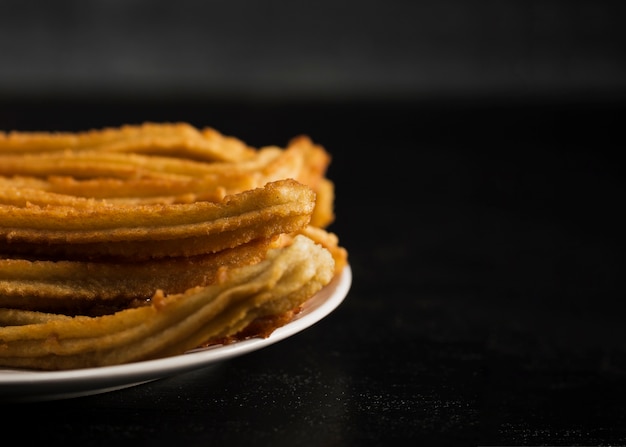 Close-up fried churros with sugar and copy space