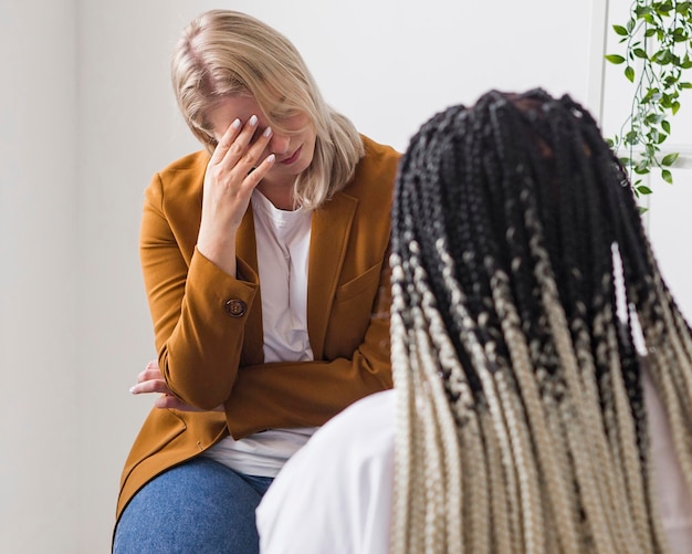 Close-up friend supporting sad woman