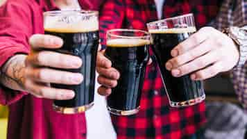 Free photo close-up of friends clinking the beer glasses