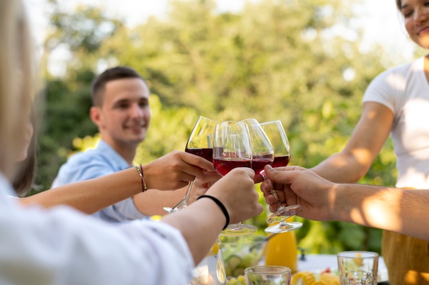 Young friends having fun outdoor clinking red wine glasses Stock Photo by  MirkoVitali