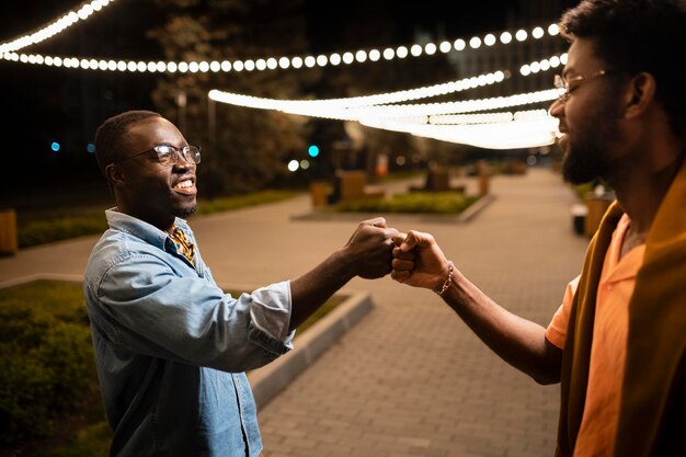 Close up friends fist bumping