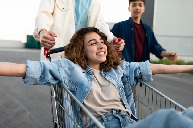 Close up friends having fun with cart