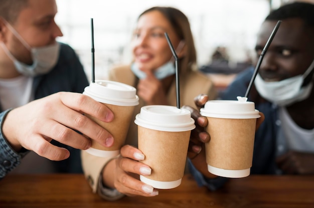 Close-up friends holding cups