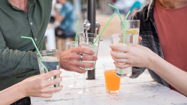 Close-up friends holding drinks