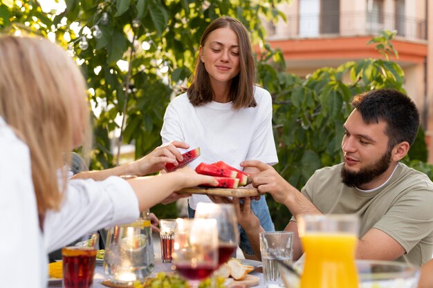 Close up friends holding watermelon slices