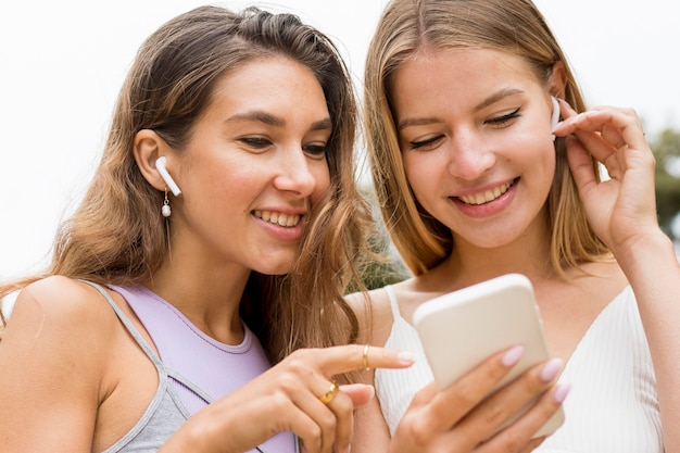 Close-up friends looking at mobile phone