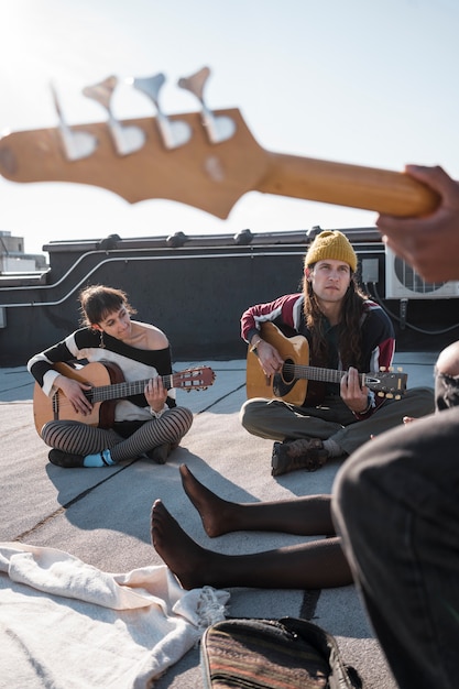 Close up friends making music together