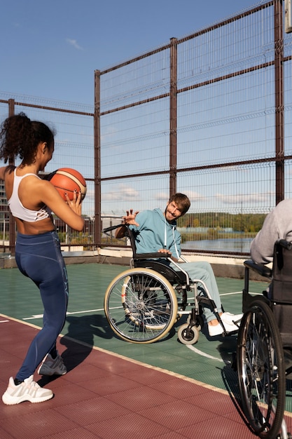 Close up friends playing basketball