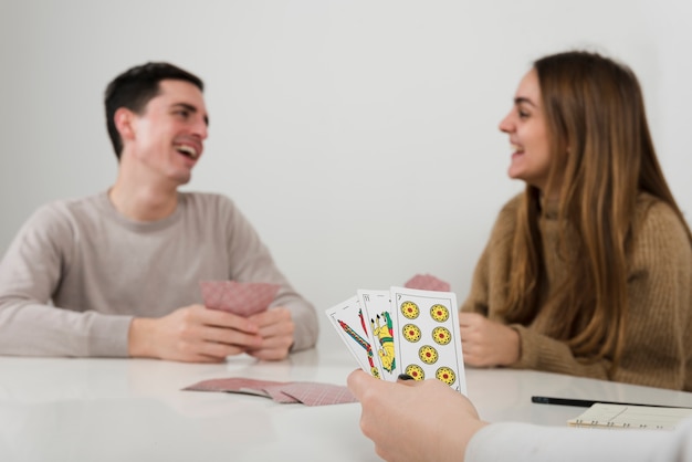 Free photo close-up friends playing cards game