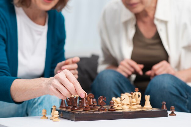 Close-up friends playing chess together