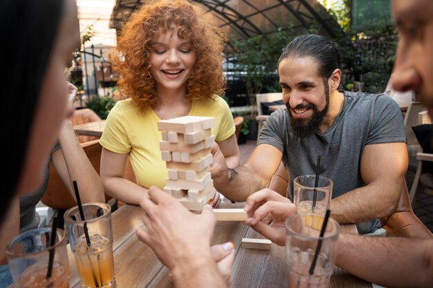 Close up friends playing game at table