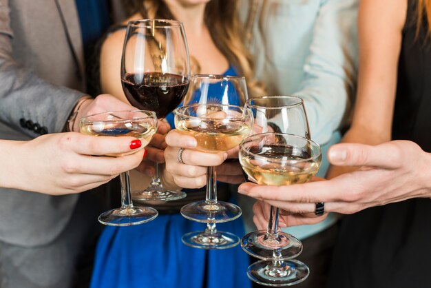 Close-up of friends toasting drinks at party