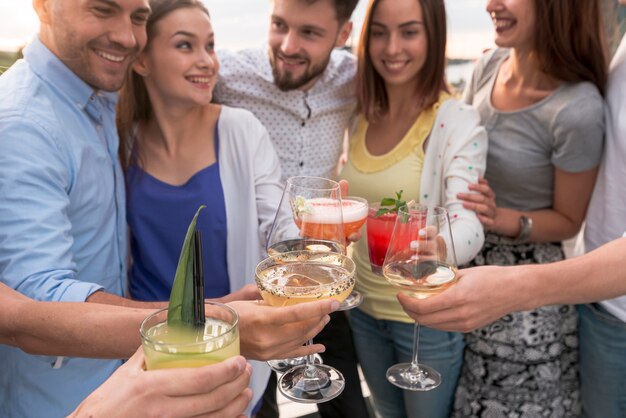 Close-up friends toasting at a party