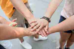 Free photo close-up friends touching hands