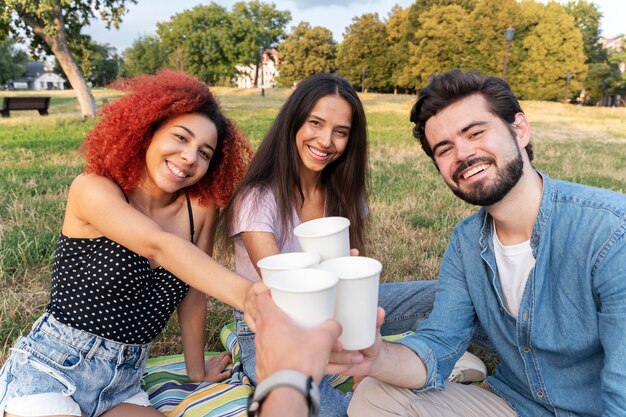 Close up friends with drinks outdoors