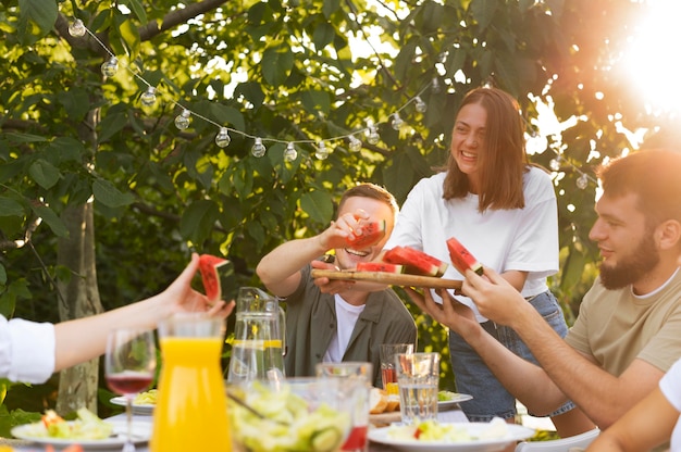 Free photo close up friends with watermelon slices