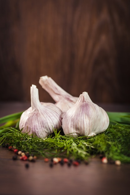 Free photo close up of garlic on green herbs