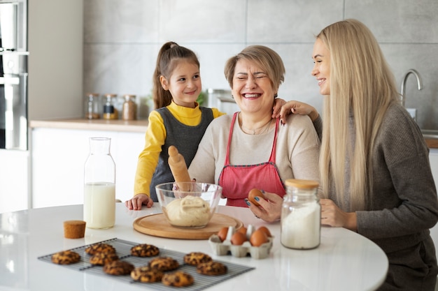 Close up on girl cooking with her mother and grandmother