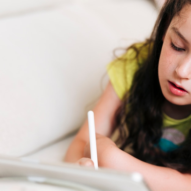 Close-up girl drawing on her tablet