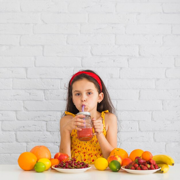 Close-up of a girl drinking strawberry smoothies