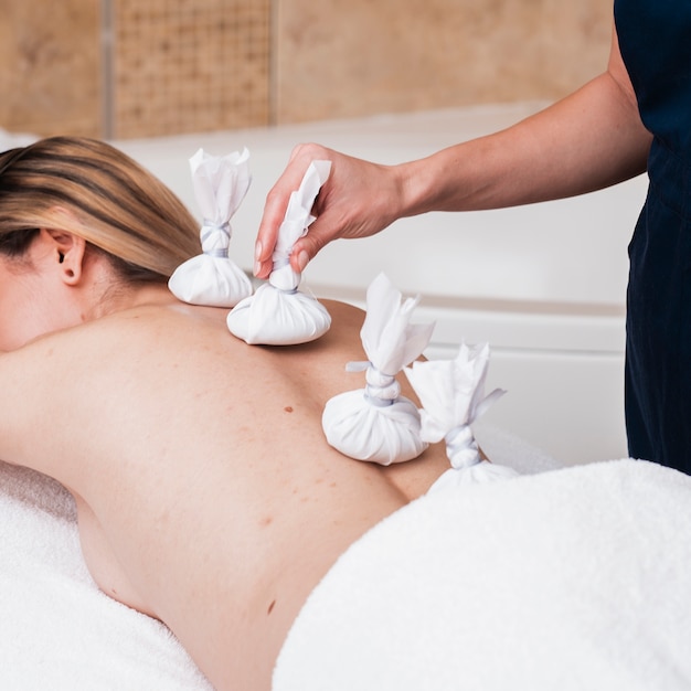 Close-up girl getting sack spa treatment