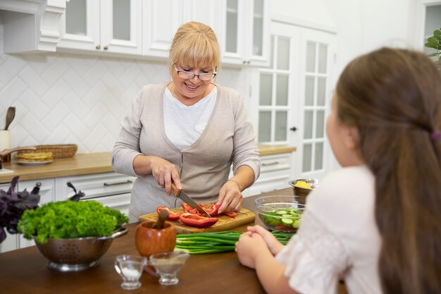 Close up girl and grandma cooking together