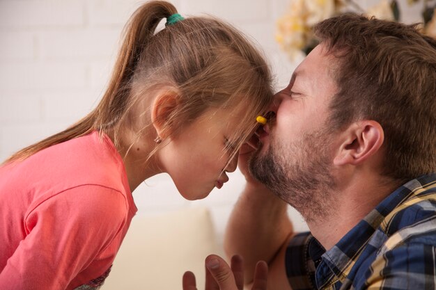 close-up of girl having fun with her father
