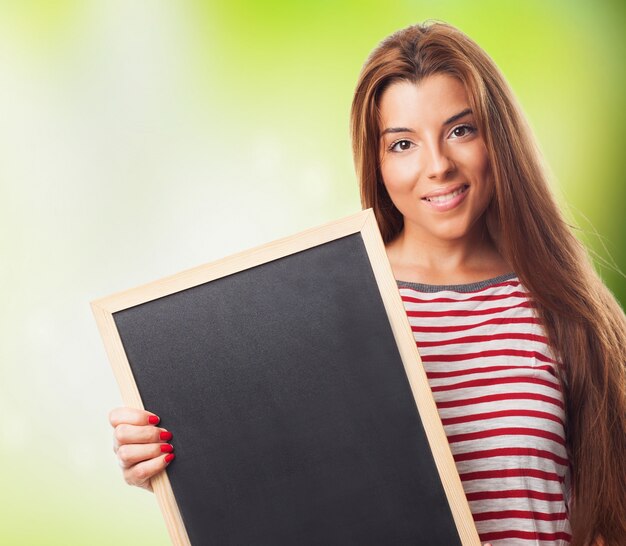 Close up of girl holding blackboard