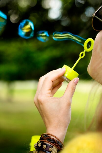 Close-up girl holding bubble machine