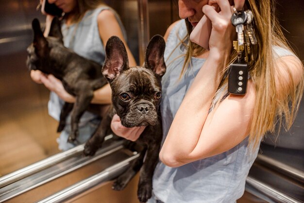 Close-up girl holding cute little puppy