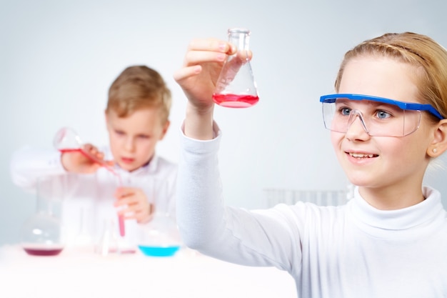 Free photo close-up of girl holding a flask with experimental substance