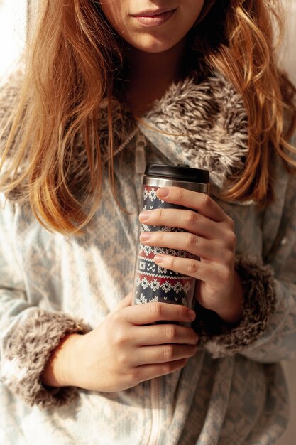 Close-up girl holding a flask